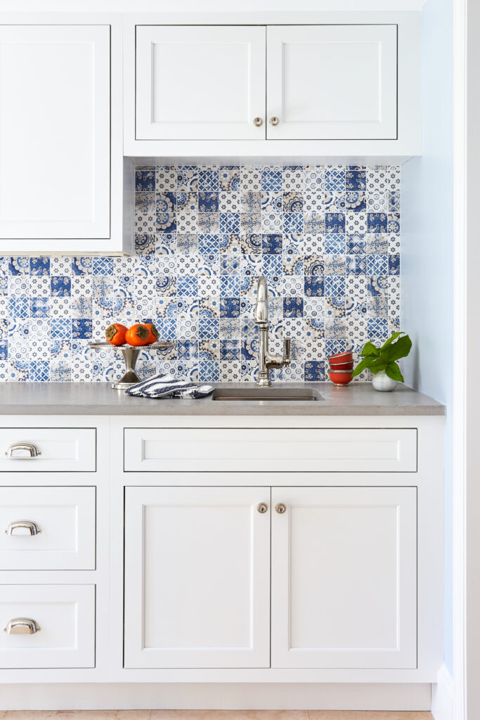 White cabinets with mixed blue tile backsplash