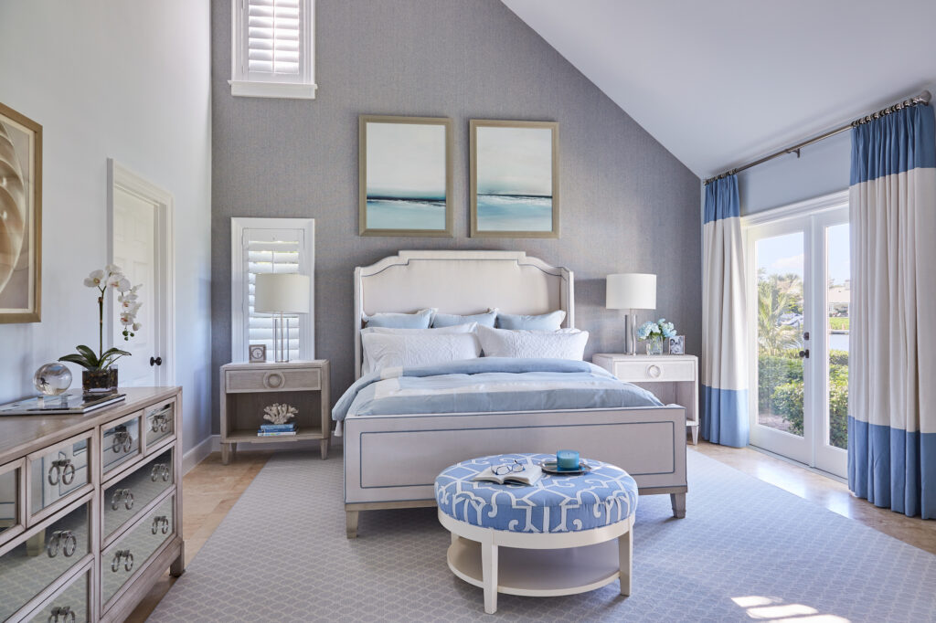 Light blue and gray primary bedroom with mirrored accent dresser