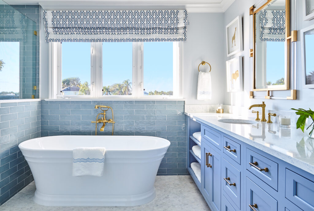 Soaking tub with blue tile and gold hardware