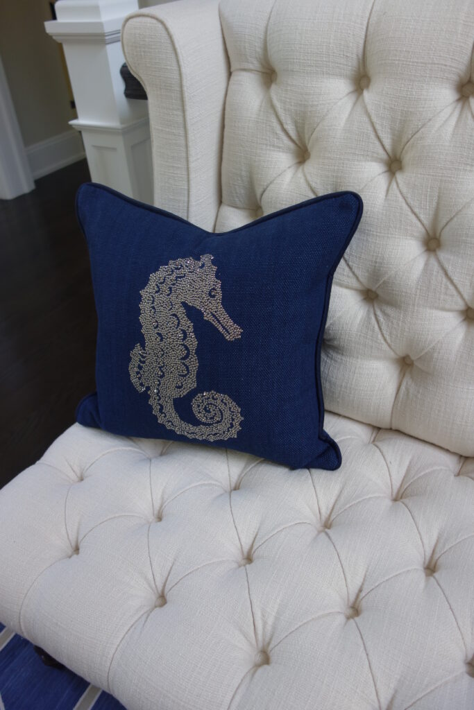 Tufted white chair with embellished pillow