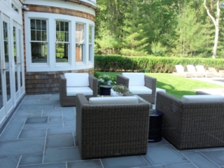 Slate stone patio with wicker chairs