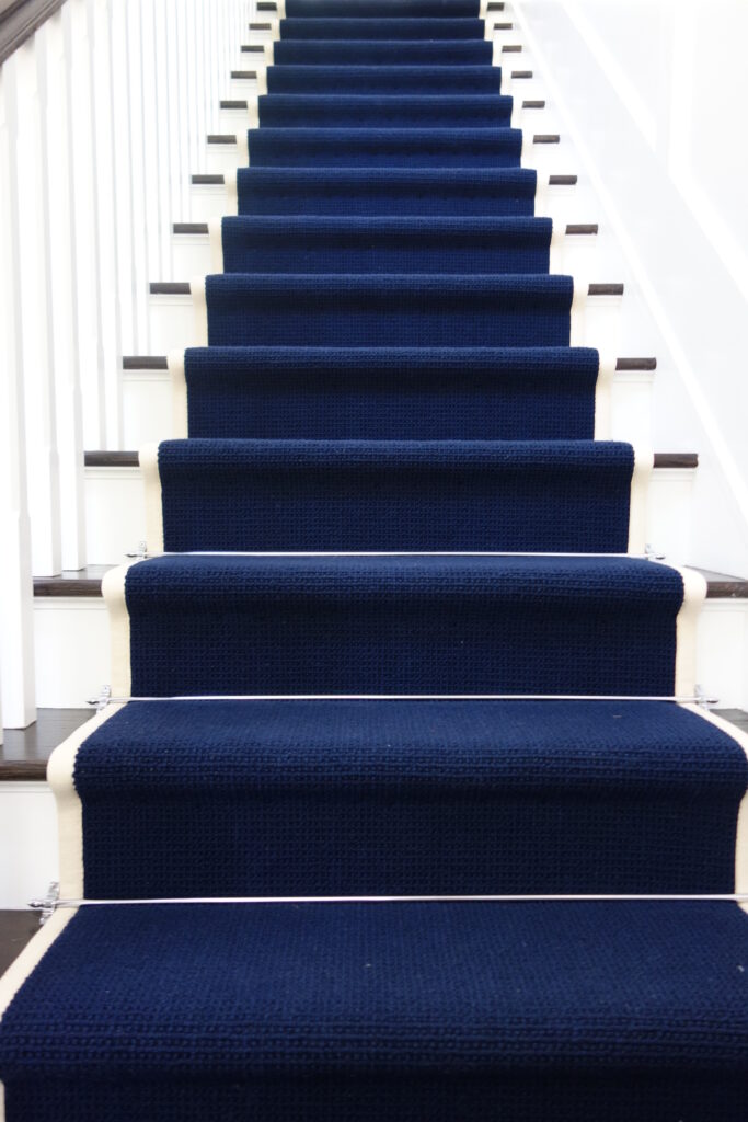 blue stair runner with silver stair rod design