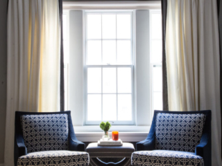 NYC apartment arm chairs near window