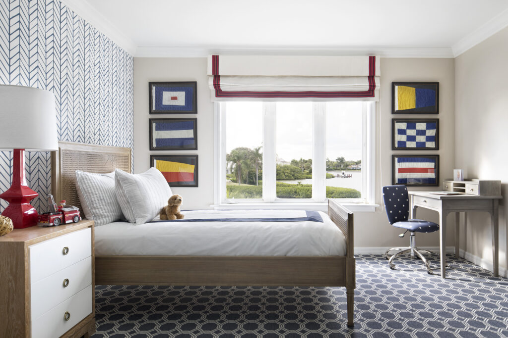 blue and white bedroom with nautical flag art