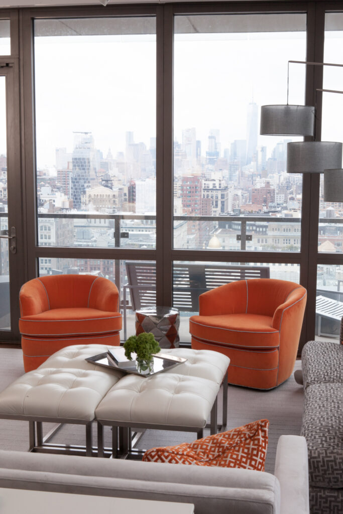 Orange accent chairs with white leather ottoman