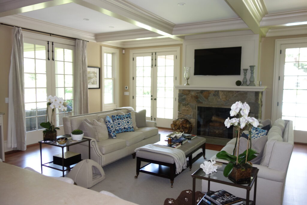 Neutral colored living room with stone fireplace