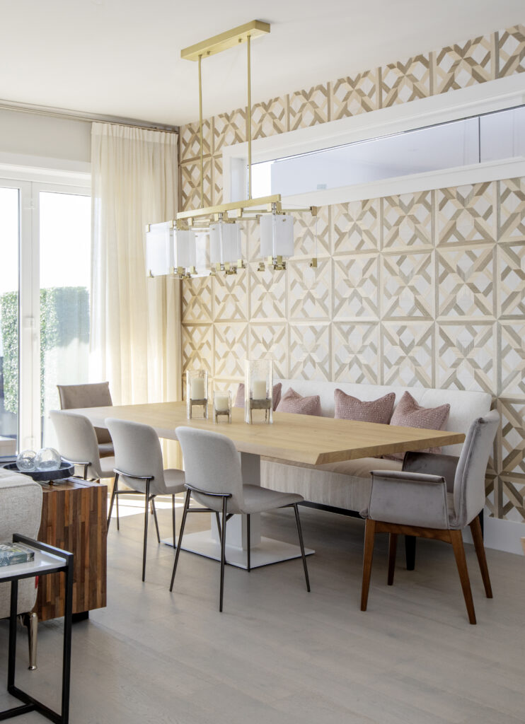 Gold patterned wallpaper behind dining table