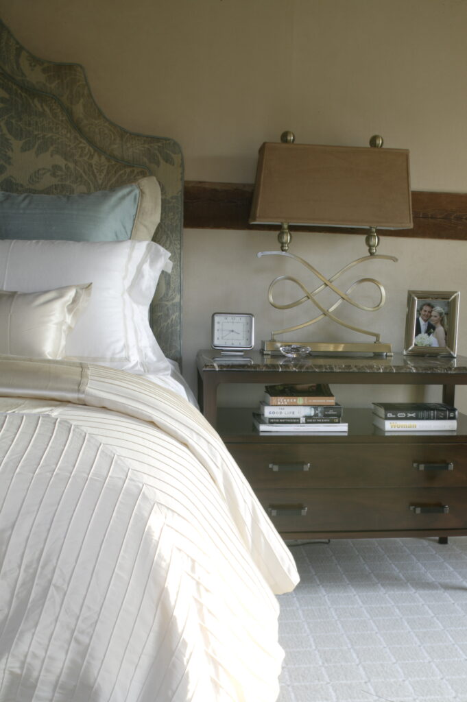 blue and creme colored bedroom with walnut