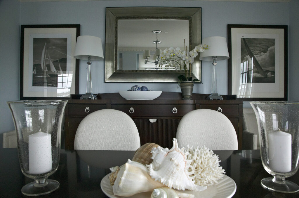 Dining room with dark wood buffet and sailboat artwork