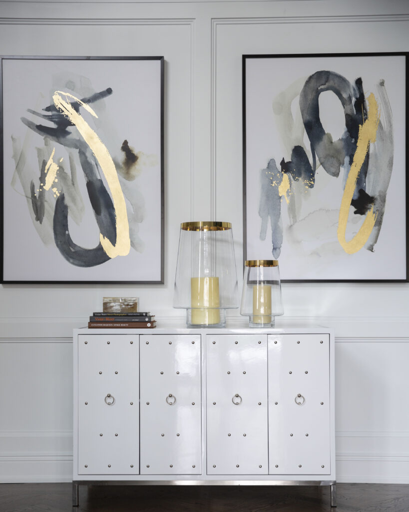 White side table with gold accented artwork