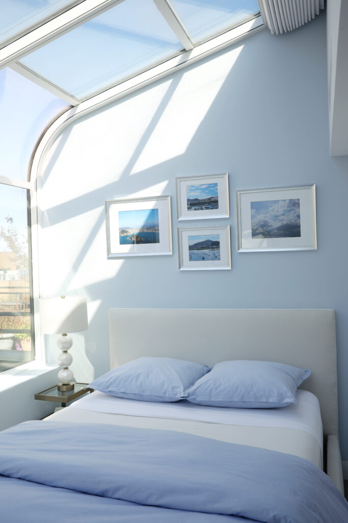 Light blue and white natural light bedroom