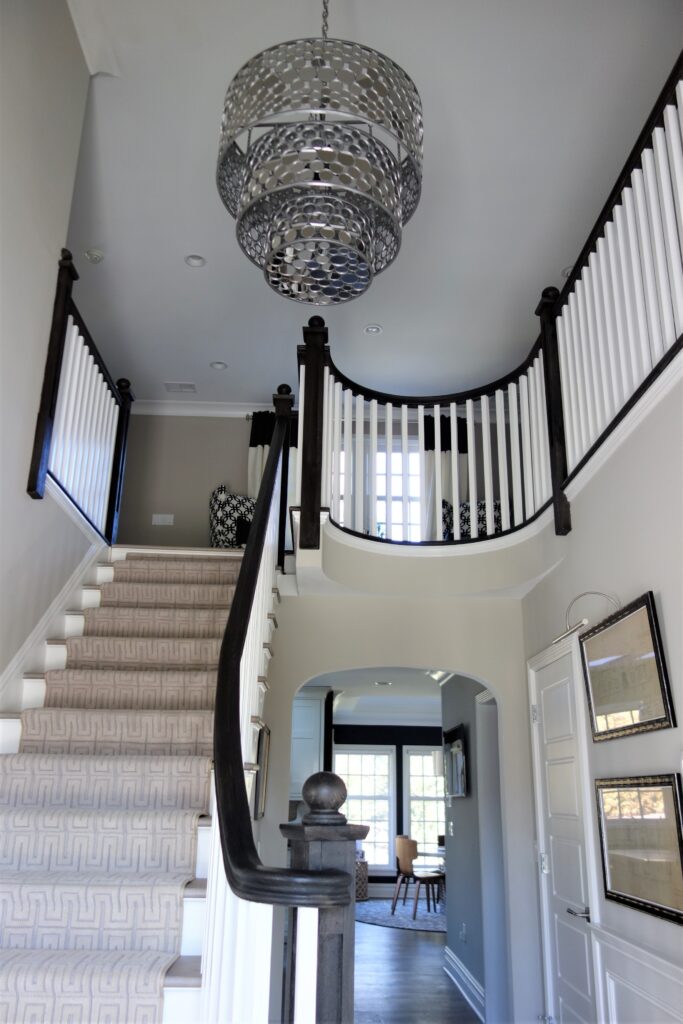 Open staircase with Large mirrored chandelier