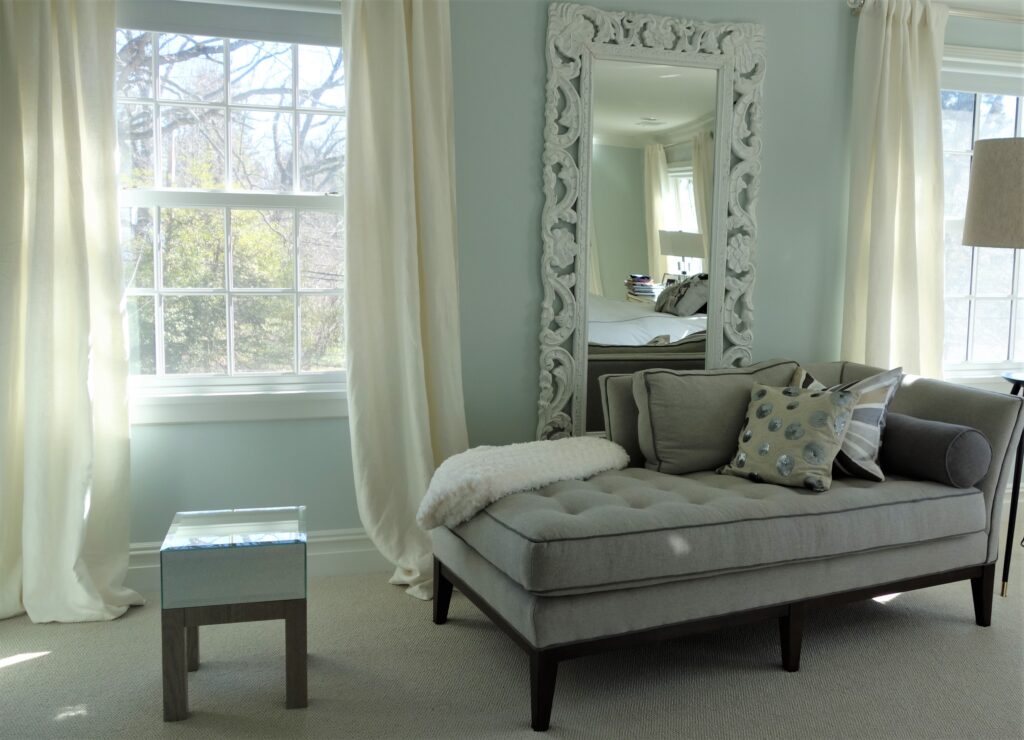 Gray bedroom chaise lounge with throw pillows