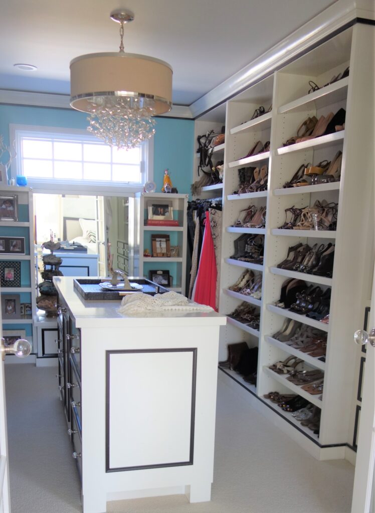 Bright walk in closet with shoe shelves
