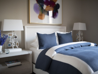blue and white bed set with colorful art
