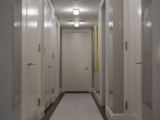 Light gray hallway with white doors