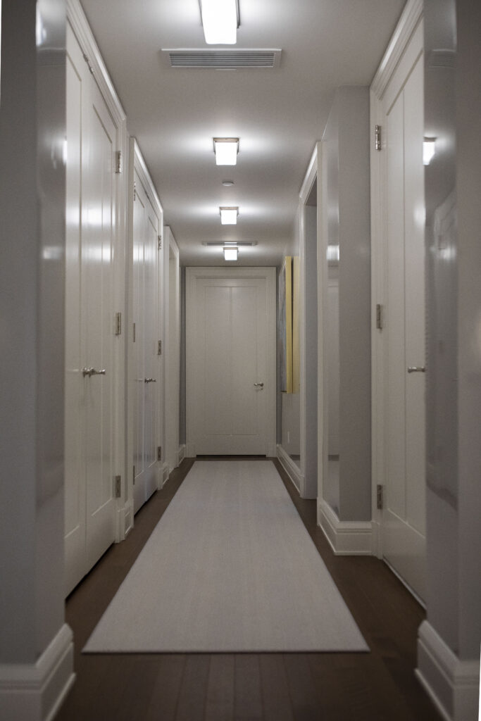Light gray hallway with white doors